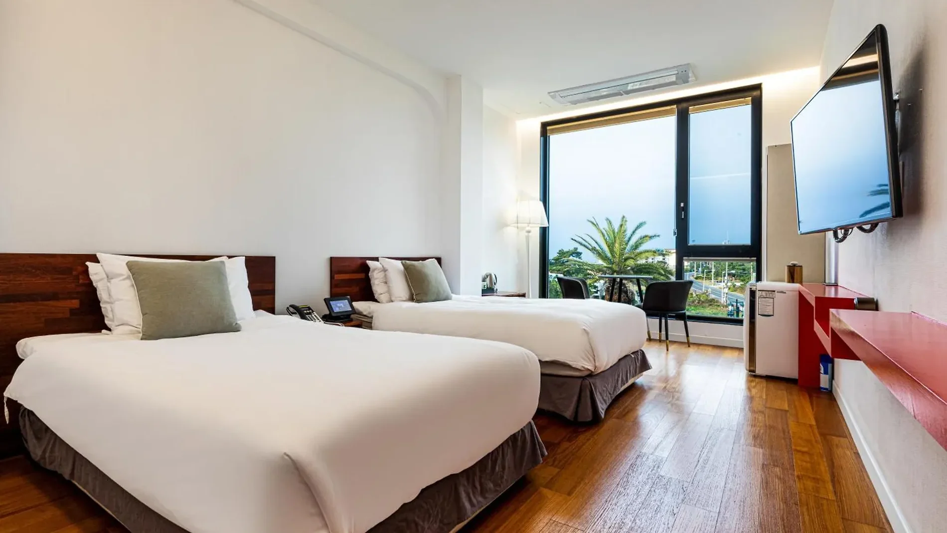 Hotel room with two beds and a large window