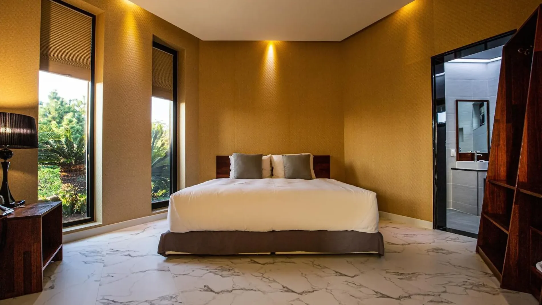 Pool villa bedroom with warm lighting