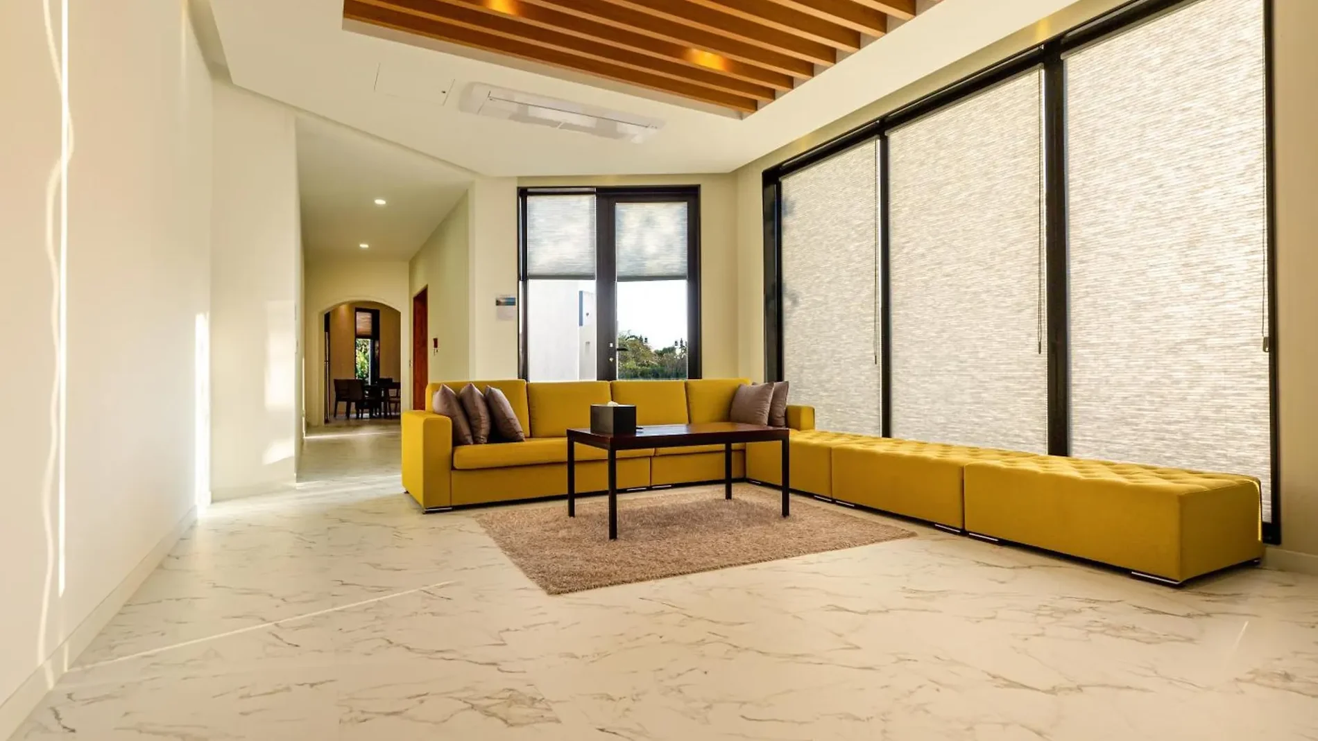 Pool villa living room with a large window and yellow sofa